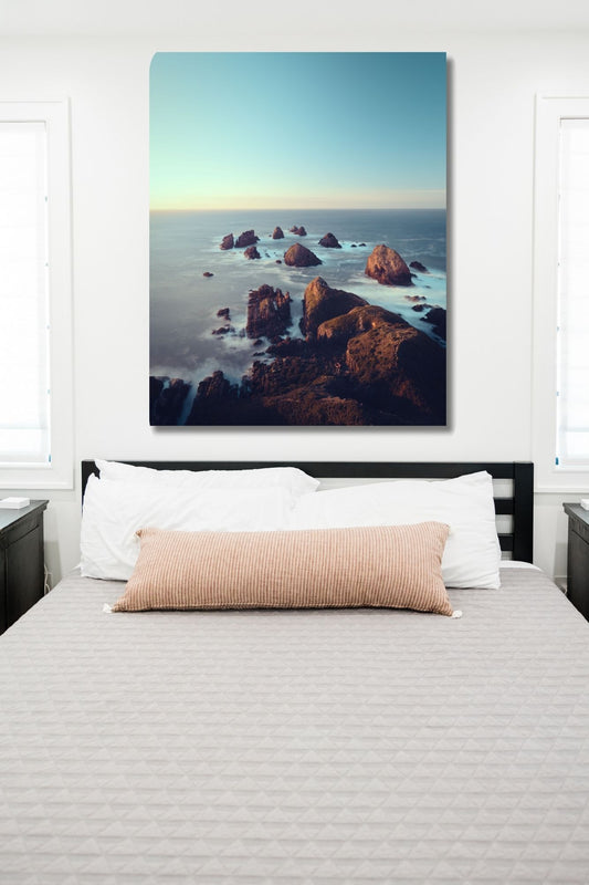 Jagged rock formations rise from misty waters
